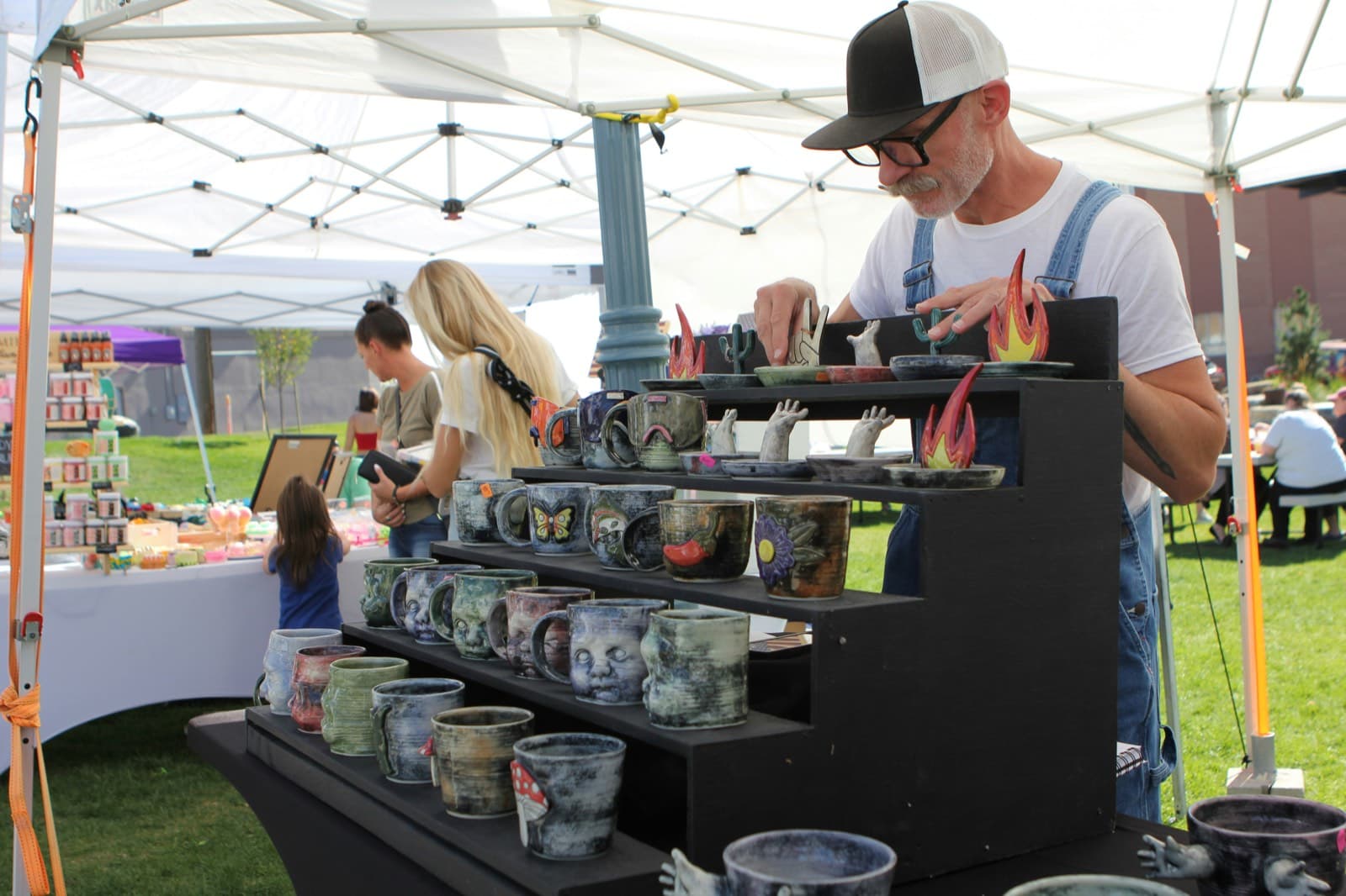 A maker setting out their stall in the hour before a market opens