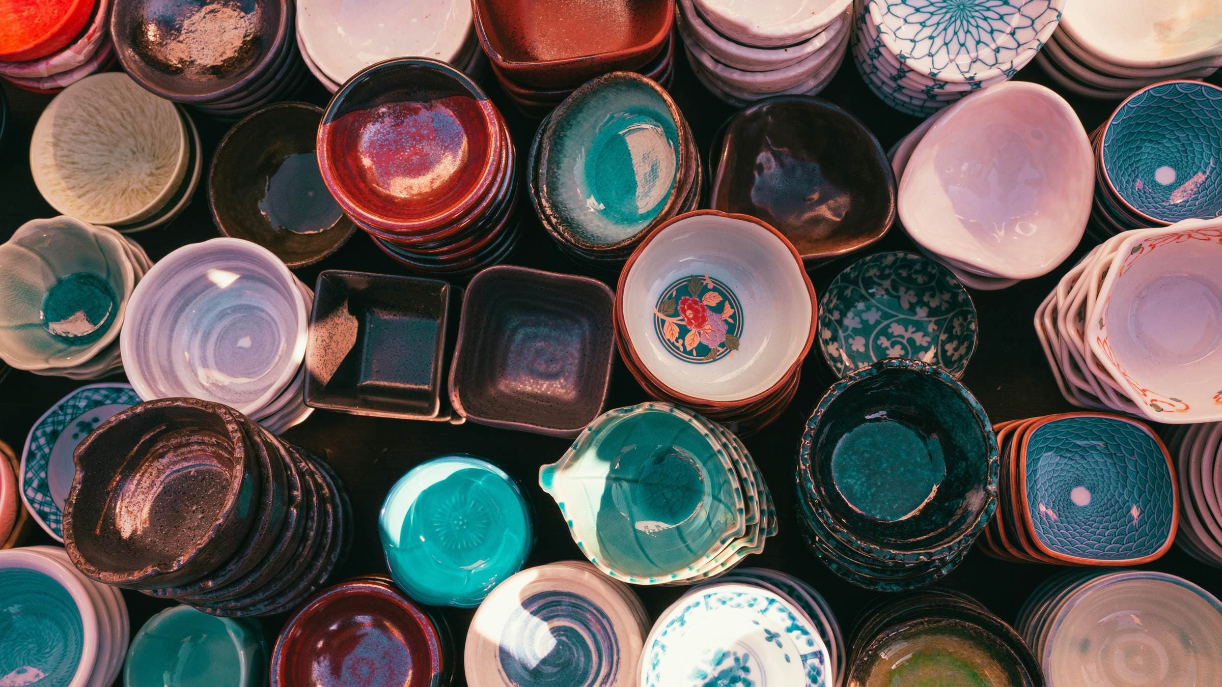A maker’s stall at a market, hand-thrown bowls set out in rows